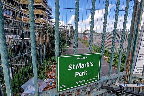 A green sign reading "St Mark's Park" with a fence in front of it