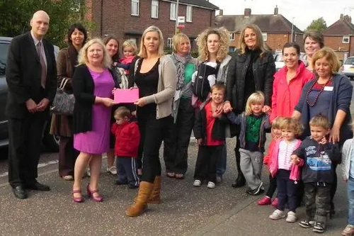 Crowd of parents outside Tanglewood nursery with local Councillors