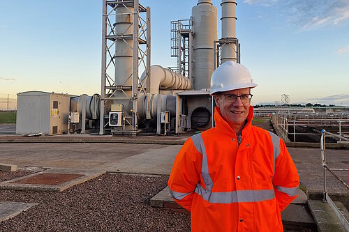 Neil Ross standing wearing a high visibility jacket