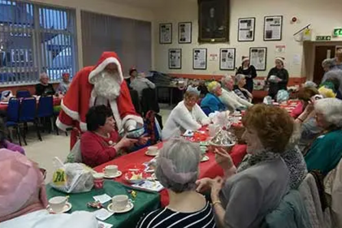 Santa Claus hands out presents at the Village Unite event