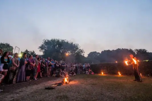 Festival goers watching fire juggling
