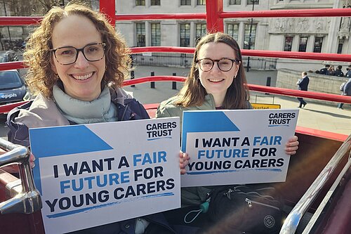 Alison Bennett MP holding sign saying I want a fair future for young carers with another activist holding a similar sign
