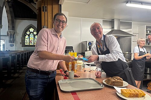 Tom being served a cup of tea by the CEO of the Harrogate Homeless Project