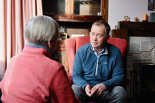 Tim listening to a resident